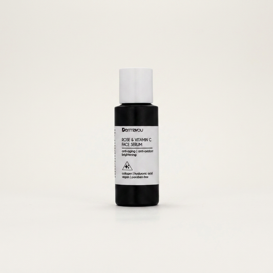 EF_rose-vitamin-c-serum_01_hero - Dermisyou Rose & Vitamin C Face Serum in black bottle with white cap on a cream editorial background